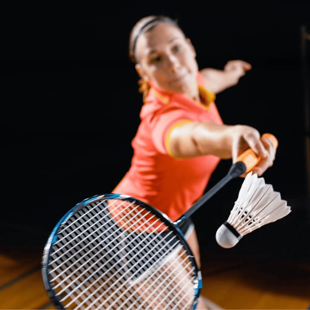 Women badminton player with red shirt playing badminton